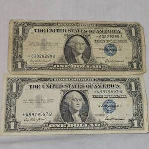lot 31 image: (2) 1957 Star Note Silver $1 Certificates