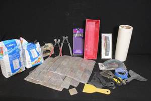 lot 28 image: Tile Installation Tools and Materials Lot with Grout, Trowels, Cutters, and Accessories