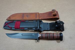 lot 51 image: Ka-Bar Dogs Head Fighting Knife with Scabbard and Leather Sheath