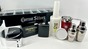 lot 155 image: Barware Lot - Cuervo Silver condiments container, Hennessy Napkin holder, SoCo Lime Bottle, Don Julio Tin, and Shaker Set - New