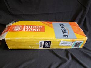 lot 19 image: Phone Stand - Yellow Retail Box with Amazon Label