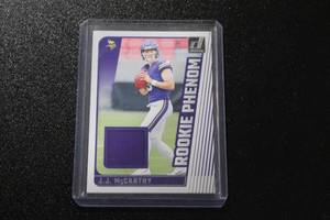 lot 100 image: 2024 Donruss Rookie Phenom Jersey Relic JJ McCarthy Rookie Card