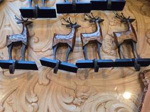 lot 843 image: Lot of (4) 8 Reindeer theme Rustic Wooden and Metal Christmas Stocking Holder Mantle Dcor