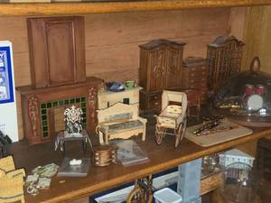 lot 915 image: Lot of  Miniature Doll House Accessories - Fireplace, Various Kitchen Buffets, Bench, Tables, Baby Carriage, Musical Instruments, Drum Kit and Horns Under Glass Dome