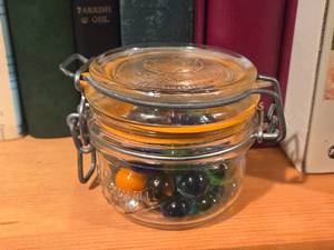 lot 972 image: Vintage Le Parfuit Super Glass Mini Canning Jar with Wire Snap Lid with Marbles
