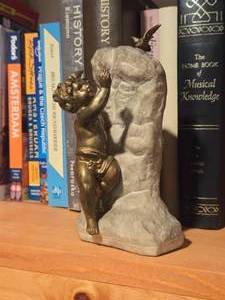 lot 975 image: Bronze Painted Cherub on Stone Display Artwork