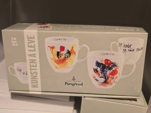 lot 1003 image: Coffee Mug Set (signed artwork design by Jan Vincents Johannessen) 2-pack - Kunsten A Leve by Porsgrund (in original packaging)