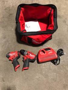 lot 22 image: Set of Milwaukee  12V cordless Drills with Charger  no batteries used not tested Customer Returns See Pictures