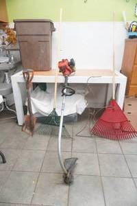 lot 182 image: Weed Trimmer, Leaf Rakes, Square shovel , lawn Ornament