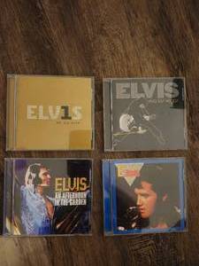 lot 114 image: collection of Elvis Presley music CDs, which are collectible items.