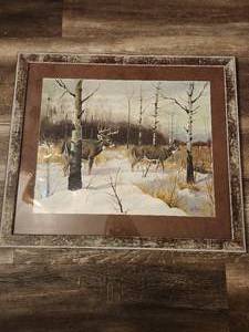 lot 138 image: Framed print of a painting of two white-tailed deer in a snowy landscape. The original artwork is by artist Les Kouba.