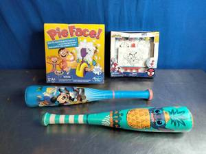 lot 69 image: childrens toys, specifically a board game, a drawing kit, and two plastic baseball bats.