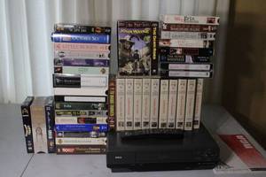 lot 16 image: RCA VHS VCR with Remote, User Guide, and 24 Movie VHS Tapes Lot