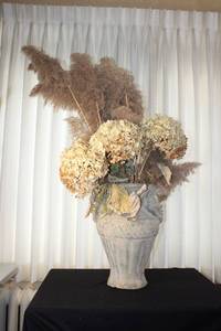 lot 18 image: Large Decorative Vase with Face Motif and Dried Floral Arrangement