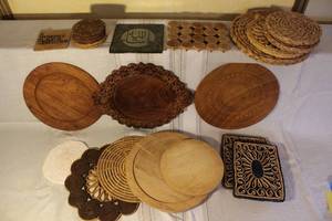 lot 31 image: Assorted Lot of Wooden and Woven Coasters, Trivets, and Decorative Plates