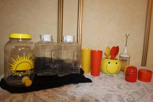 lot 88 image: Vintage Sun Tea Jar, Glass Pitchers, Smiley Face Utensil Holder, Tumblers and Kitchenware Set