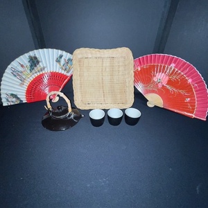 lot 261 image: Asian-Inspired Tea Set with Teapot, 3 Cups, 2 Decorative Fans, and Wicker Tray