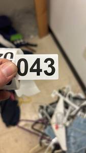 lot 43 image: Large Lot of Mixed Clothing Including Shirts, Jackets, and Outerwear