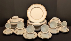 lot 22 image: LL - Christofle Ruban Porcelain Dinnerware Set, 40 Pieces, Gold Trim