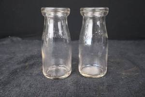 lot 387 image: Milk Bottle Pair - Clear Glass, Embossed Text