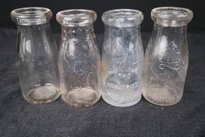 lot 390 image: Embossed Clear Glass Bottles - Pine Tree Motif & Company Logos (Set of 4)