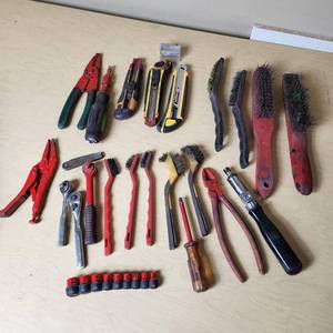 lot 55 image: Assorted hand tools including Craftsman ratchet, wire strippers, utility knives, brushes, and sockets