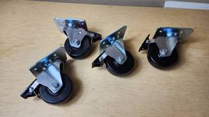 lot 260 image: Heavy-duty swivel casters with brakes set, including mounting plates and locking mechanisms