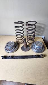 lot 461 image: Dodge Automotive Parts Lot including Springs, Hubcaps, and Other Components