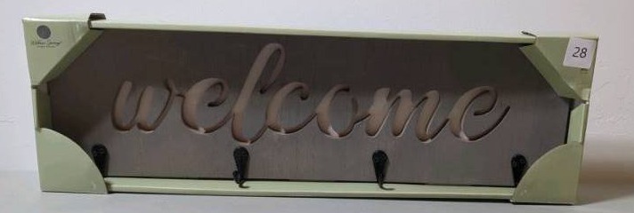lot 28 image: Willow Spring Grey Welcome Sign carved in cursive with black hooks 19 in X 6