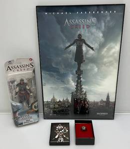 lot 151 image: Collectible ASSASSINS CREED Items Including Framed Poster And Unity Ring In Original Box & McFarlane Aveline Action Figure (NEW OLD STOCK)