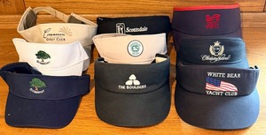 lot 142 image: 9 Golf Visors with Assorted Club Logos