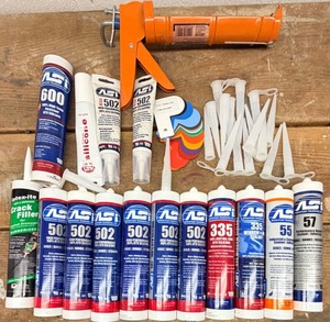 lot 173 image: American Sealants 502 Silicone Tubes, 335 Window Sealant Kit with Caulking Gun and accessories. Items are unopened.