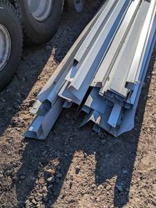 lot 20 image: Assorted pile of mixed aluminum J&F Channel siding trim 10 ft long some small mixed parts - White