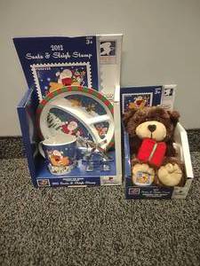 lot 65 image: USPS 2012 Santa and Sleigh, Teddy Bear. No Stamps Plushie, plate, cup, cookiee cutter