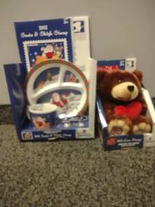 lot 67 image: USPS 2012 Santa and Sleigh, Teddy Bear. No Stamps Plushie, plate, cup, cookiee cutter