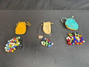 lot 77 image: Collection of Vintage Marbles in Suede Drawstring Bags