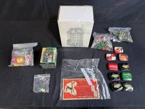lot 82 image: Dept 56 & Mixed Holiday Collectibles Lot with Dickens Village, Berta Hummel Figure, Vintage Tins, and Ornaments