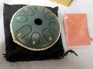 lot 141 image: Steel Tongue Drum with Music Book...