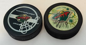 lot 253 image: 2 Minnesota Wild Signed Hockey Pucks (Players Unknown)