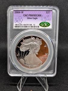 lot 100 image: U.S. Mint American Silver Eagle 2004-W 1 oz .999 Fine Silver CAC PR69DCAM Purple Toning