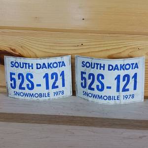 lot 53 image: 2 Vintage Paper Snow Machine Plates from South Dakota 1978
