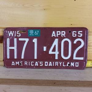 lot 63 image: 1965 Wisconsin embossed plate12 inches- Americas Dairyland