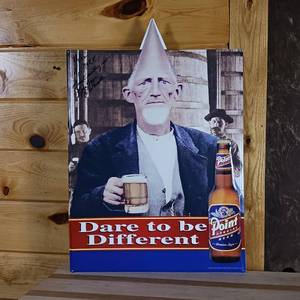 lot 133 image: Metal Sign Signed by John Zappa � Dare to be different featuring Point Pointy Head Guy