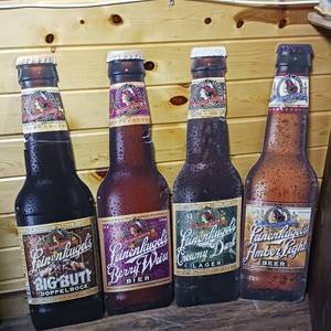 lot 155 image: Four piece lot of giant cardboard Leinenkugel 2 sided signs � Big Butt Dopplebock � Berryweis Bier � Creamy Dark Lager � Amber Light � Oktoberfest Lager � Red Lager