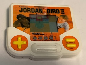 lot 65 image: Jordan vs. Bird One on One Handheld Electronic Basketball Video Game