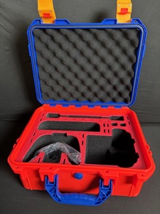 lot 14 image: Red Protective Case with Blue Handle and Yellow Latches