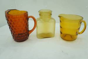 lot 601 image: Vintage Amber Glass Pitchers and Water Decanter