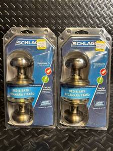 lot 105 image: Schlage F40 V GEO 609 Antique Brass Bed & Bath Privacy Knob - 2-pack