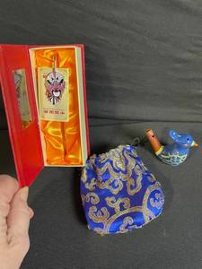lot 153 image: Peking Opera Mask Brooch on Pin - Silk Damask Pouch - Ceramic Bird Figurine - 4-Piece Set