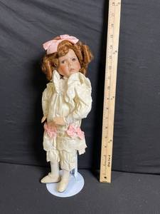 lot 202 image: Porcelain Bisque Head Doll - Cream Lace Dress with Pink Ribbon Bows & Stand